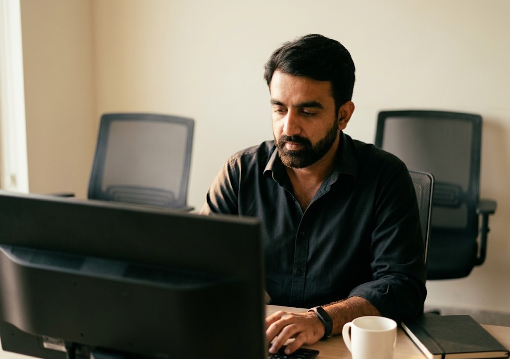 A member of the Growise Tech team at work at his desk